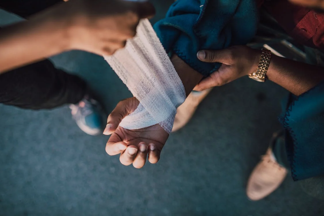 https://www.pexels.com/photo/person-putting-bandage-on-another-person-s-hand-6519904/